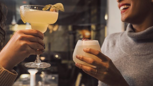 Girlfriends laughing with cocktails