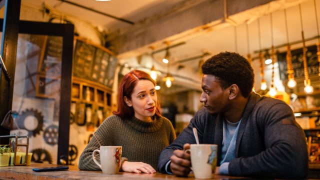 Jealous young woman have a fight with her boyfriend at the modern cafeteria
