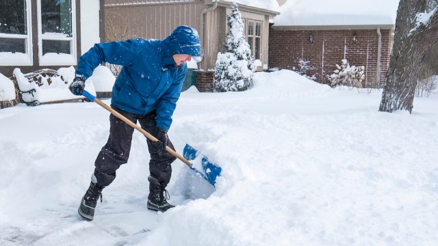 Man,Removal,Snow,With,A,Shovel