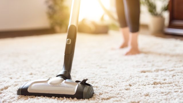 woman using vacuum