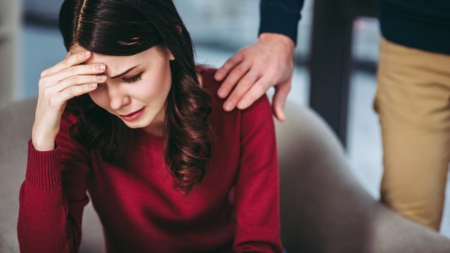 Portrait,Of,Depressed,Woman,Sitting,In,The,Armchair,And,Man