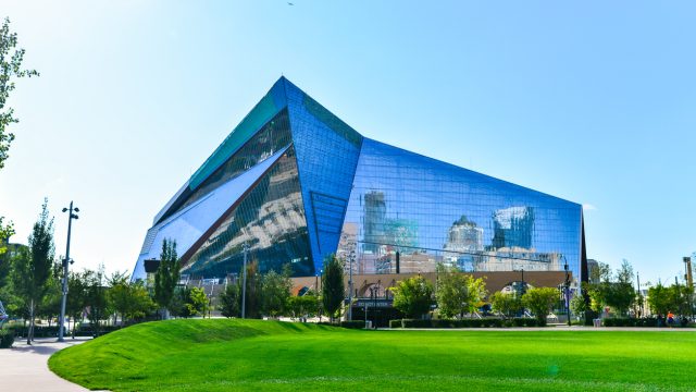 The exterior of US Bank Stadium in Minneapolis with green grass in front of it