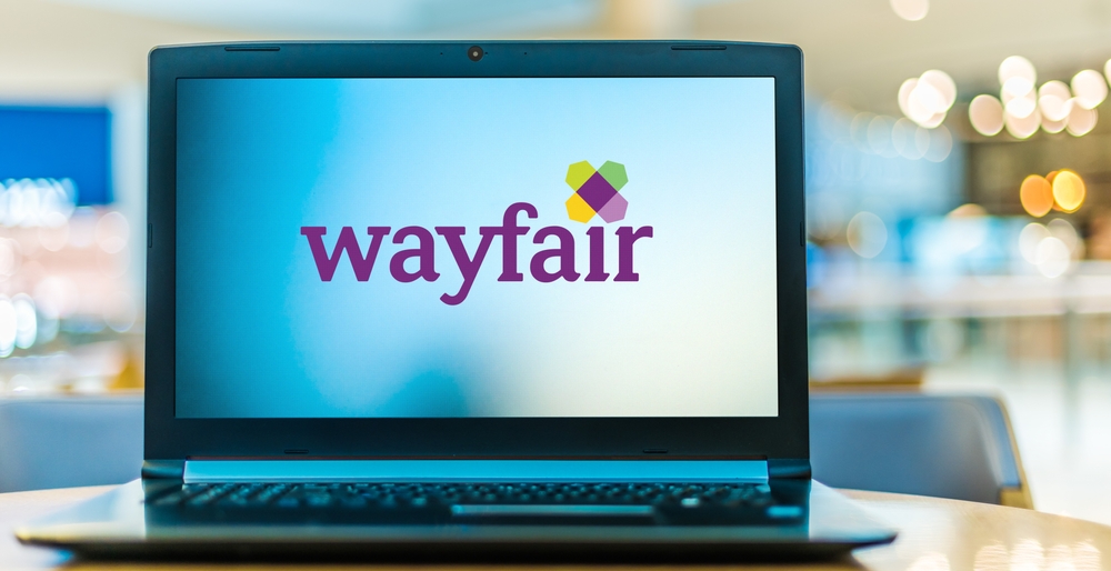 A laptop with the Wayfair logo on the screen