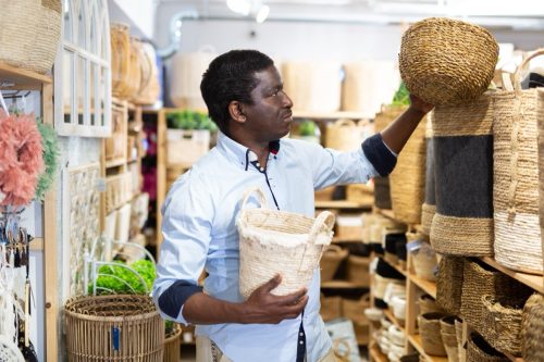 Man shopping for baskets at HomeGoods store.