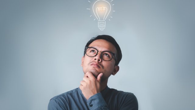Young Man With Light Bulb Above His Head