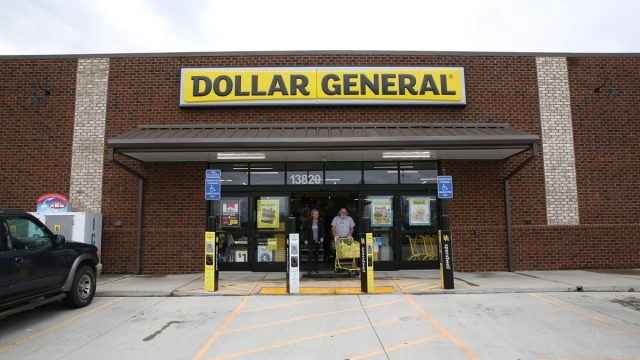 The customers exiting Dollar General with carts full of items