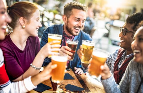 Friends sitting outside drinking beer
