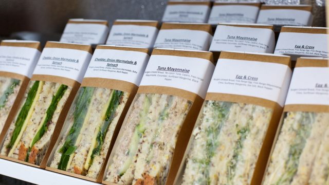 Pre-made sandwiches in packages sitting in a fridge
