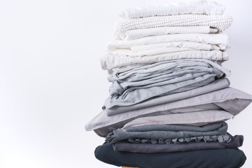 A stack of grey and white folded sheets.