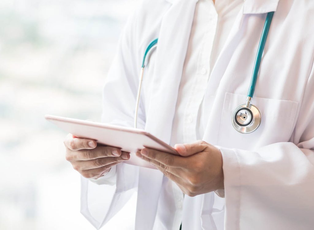 Close up on doctor holding an iPad