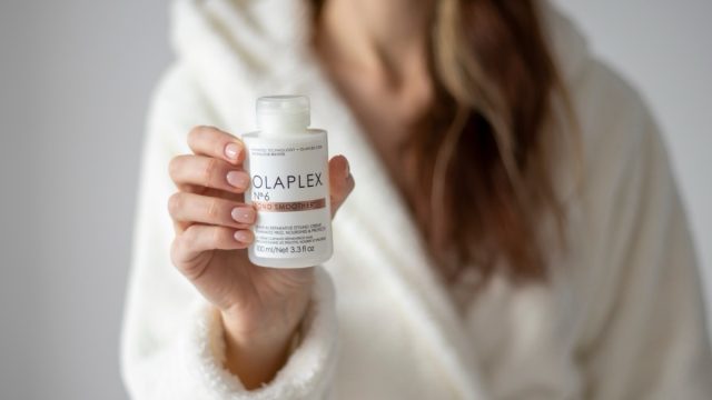 woman holding olaplex bottle