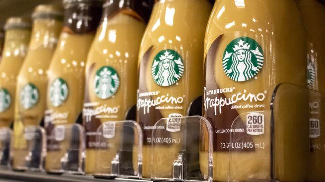 A close-up of Starbucks Frappuccino bottled coffee drinks on a grocery store shelf
