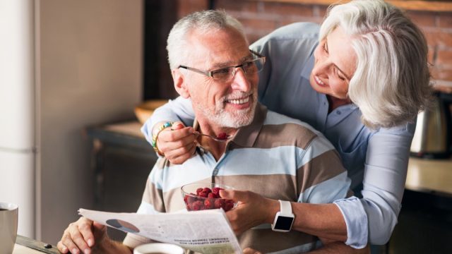 woman feeding man berries, one of the best foods to eat for penis health