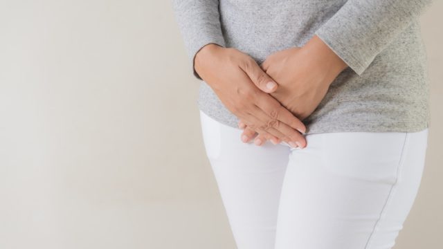 Woman holding her pee