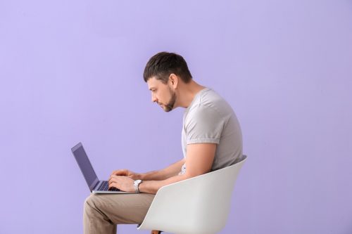 man slouching on his computer