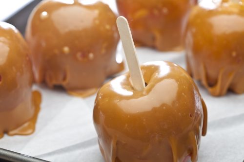 caramel apples on parchment paper