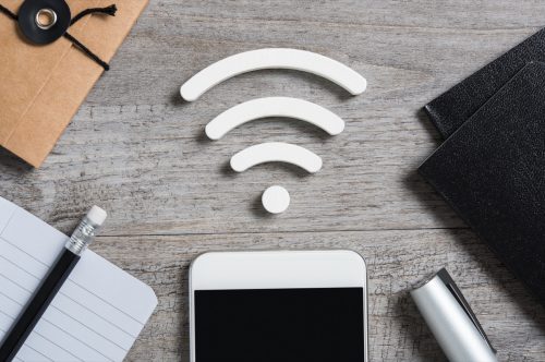 Top view of smartphone on desk searches a free wifi connection available.