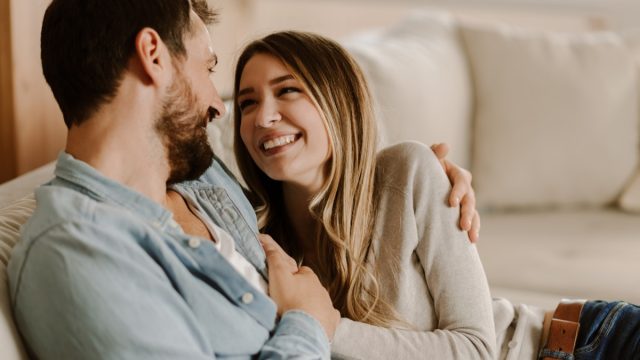 Loving happy couple talking to each other at home