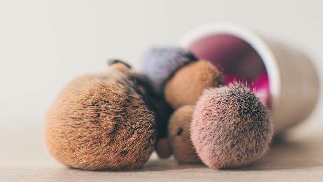 Professional makeup brushes in tube. Dirty makeup tools.