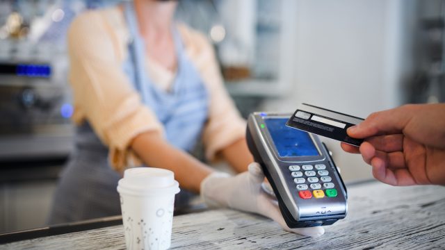 Close up of a person paying for a coffee with a card