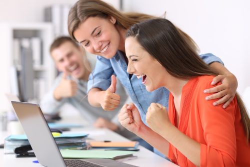 woman congratulating her coworker