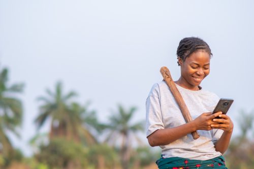 african farmer using her phone