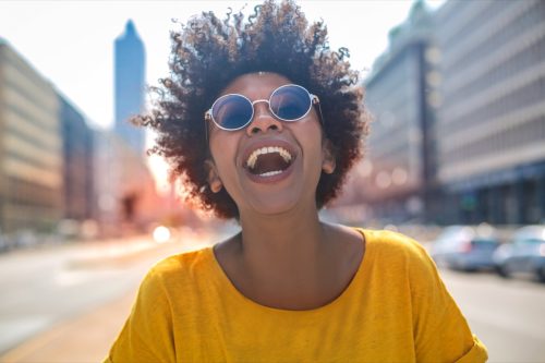 woman in yellow shirt smiling