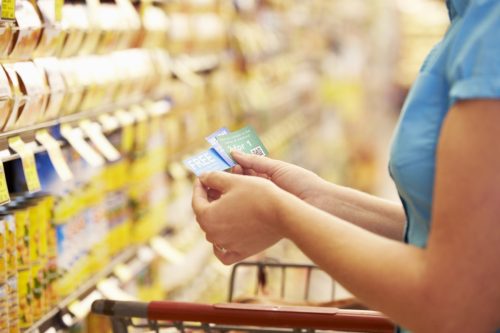 person finding coupons on store shelves