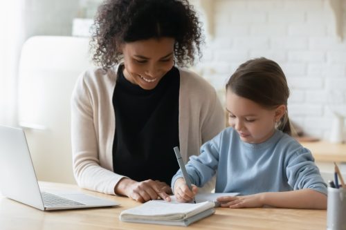woman tutoring young girl
