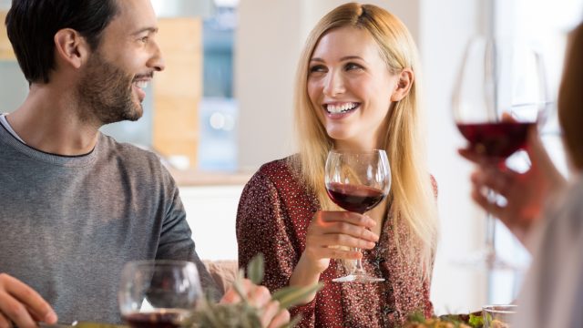Laughing friends having dinner