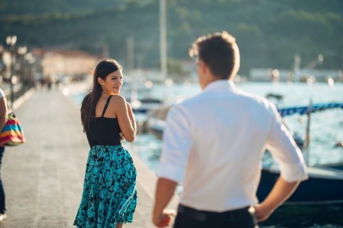 woman smiling as she receives a compliment from her boyfriend