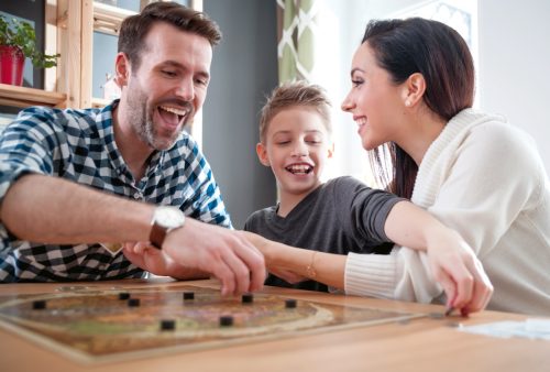 family celebrating father's day with a game night