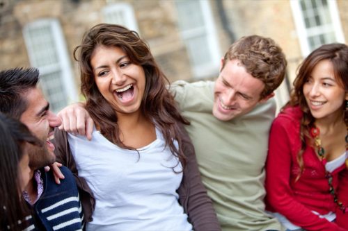 group of friends laughing together and embracing