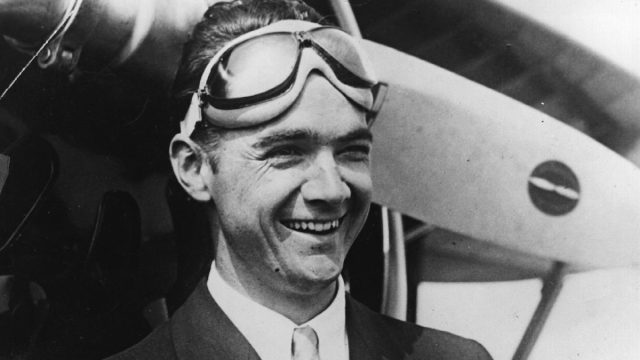 Howard Hughes standing in front of a plane