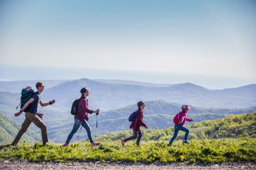 family of four hiking through the mountains