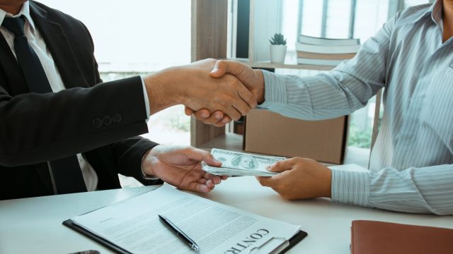 Business deal with cash and contract