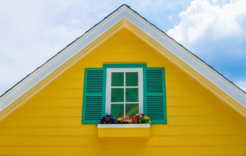 yellow house with green shutters