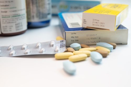 collection of antibiotic pills and pill boxes