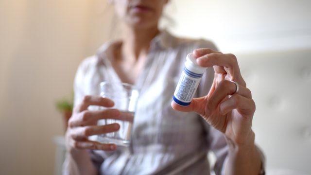 Woman in her room taking medication