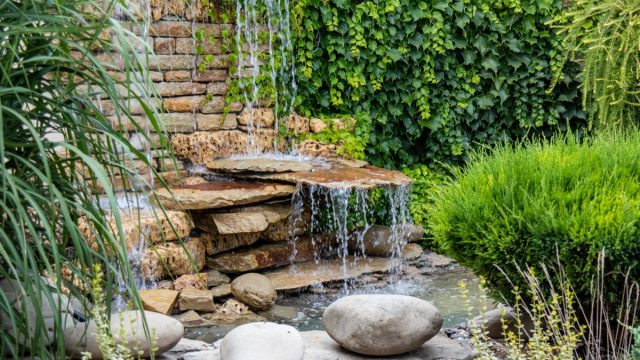 A small decorative waterfall in the garden. Landscape design feng shui