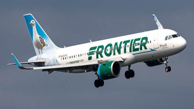 Frontier airplane flying in the sky to destination.