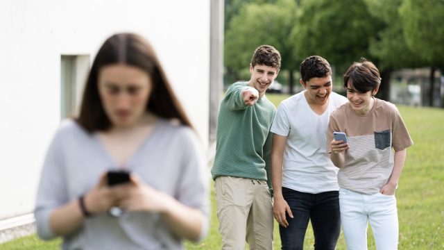 Group of Boys Laughing at a Girl