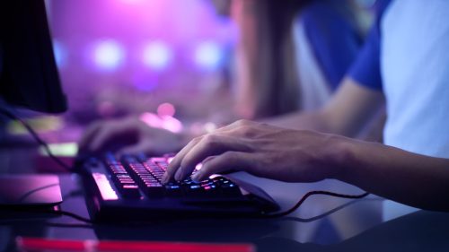 close up of an online gamer's hands on keyboard and mouse