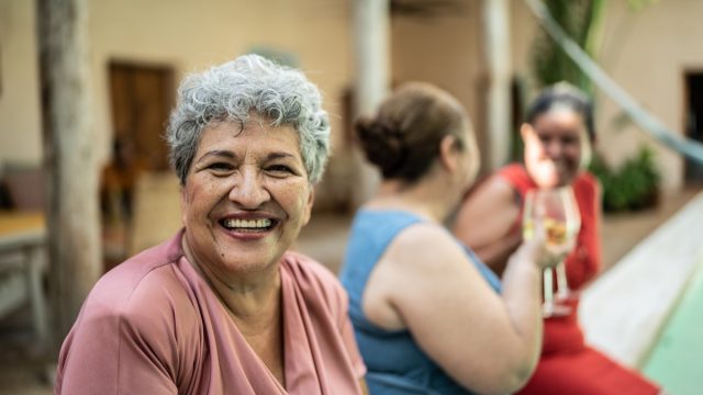 Portrait of senior woman sitting by the pool