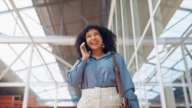 Phone call, smile or black woman travel in airport, office building or street for communication, networking or 5g network. London, tech or happy girl with smartphone walking, commute or travelling