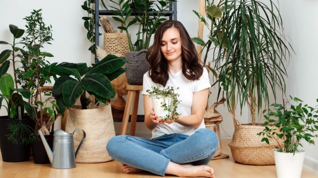 Woman Sitting on floor With Houseplants