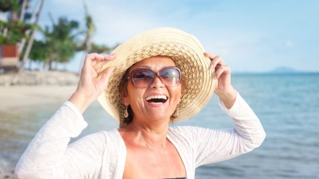 Happy mature woman of 50 60 years on the beach