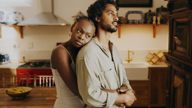 Shot of an attractive young woman hugging her boyfriend while bonding with him at home