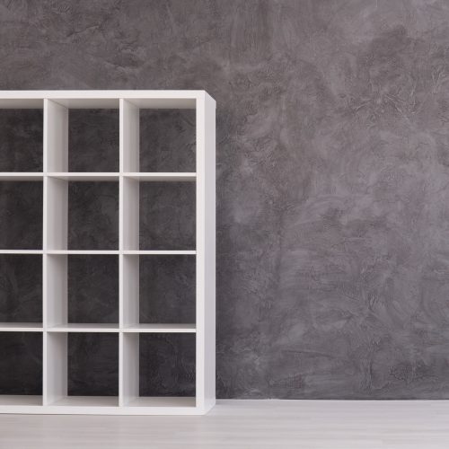 shelving unit next to gray wall