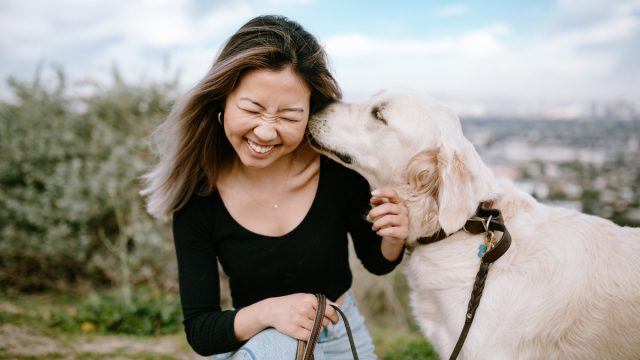 Portrait of Young Woman Hugging Her Dog